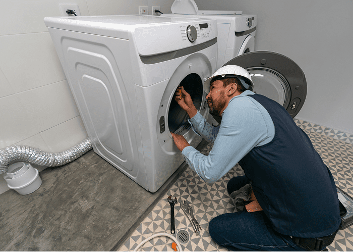 Engineer working on laundry appliance