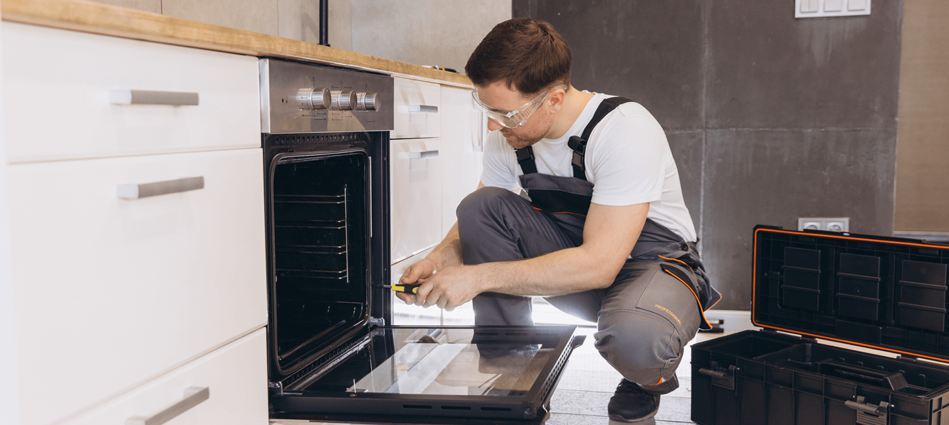 Repairman fixing kitchen oven