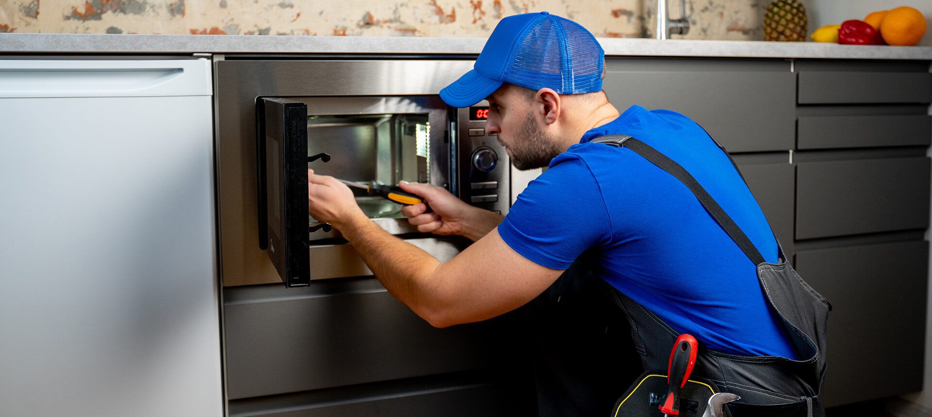 Repairman working on microwave appliance