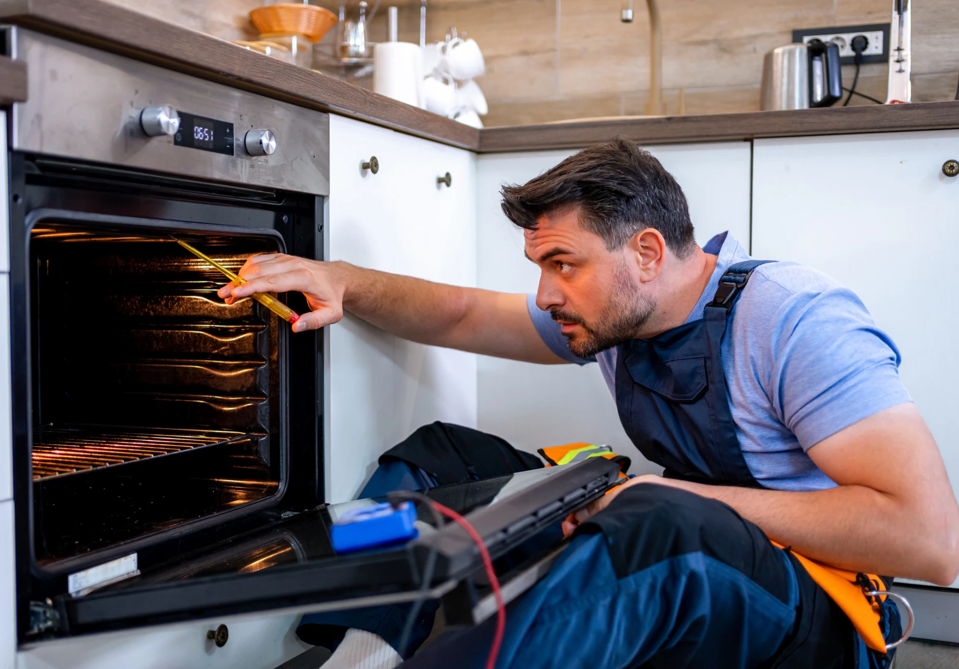 Man inspecting kitchen oven