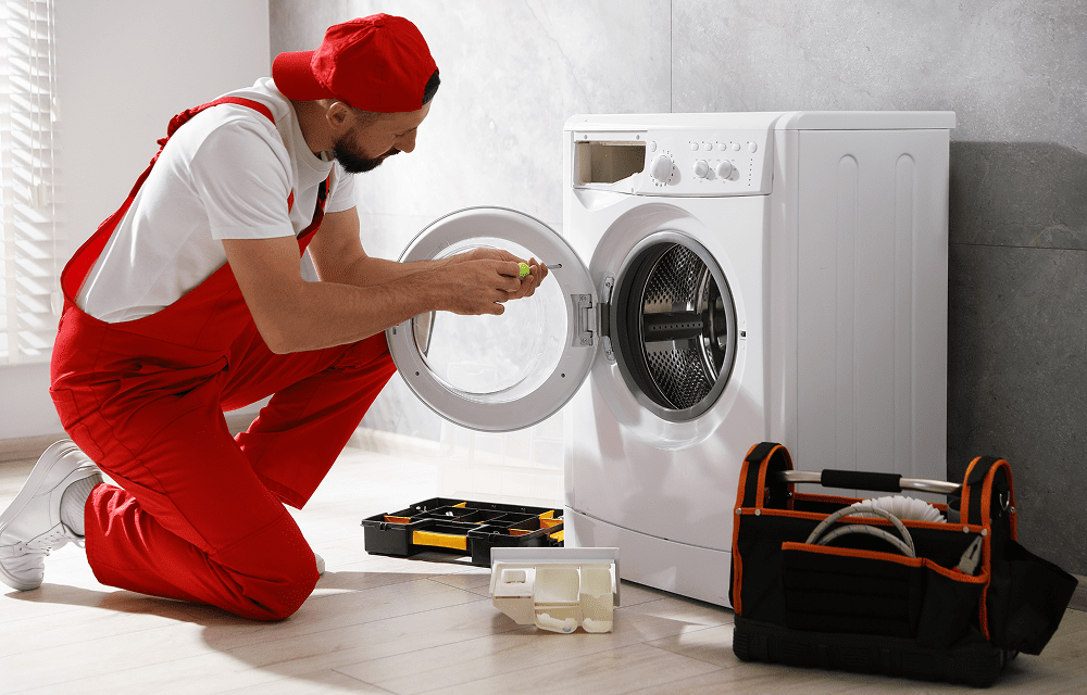 Technician working on laundry appliance